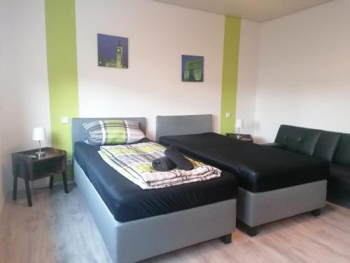 a bed and a couch in a room at Ferienwohnung Körner in Saarbrücken