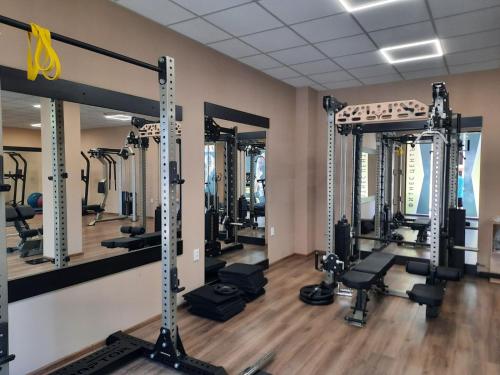 a gym with several tread machines in a room at Lilia Apartments Каваци, Созопол in Sozopol