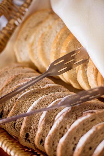 a basket of bread with a fork on top of it at Hotel Regal in Braşov