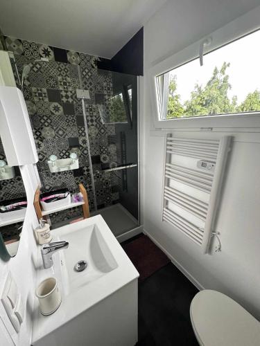 a bathroom with a white sink and a window at BLUE BAY in Mosty