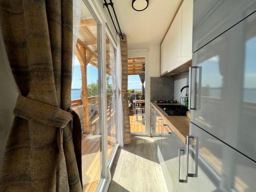 a kitchen with glass doors and a view of the ocean at Mobile home d-view in Drage
