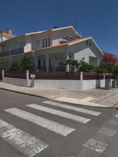 a house with a crosswalk in front of a street at Couto Sá in Entroncamento