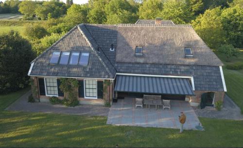 an aerial view of a house with a roof at The nicest farmhouse in Holland! in Epse