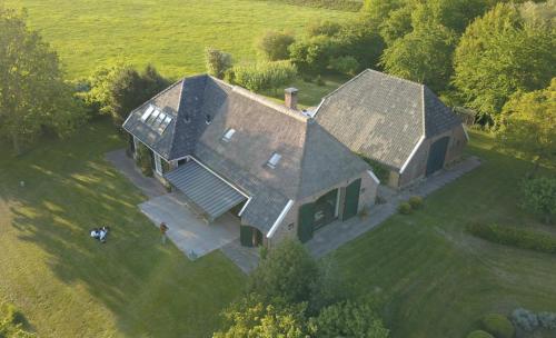 an aerial view of a large house in a field at The nicest farmhouse in Holland! in Epse