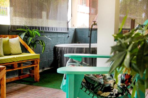 a room with a table and a chair and a tub at Casa Isabel in Rincon