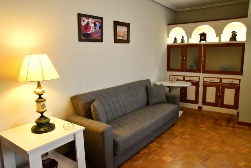 a living room with a couch and a table at Puerta la Villa in Avilés