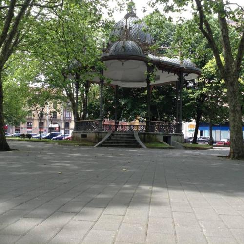 a large gazebo in a park with trees at Puerta la Villa in Avilés