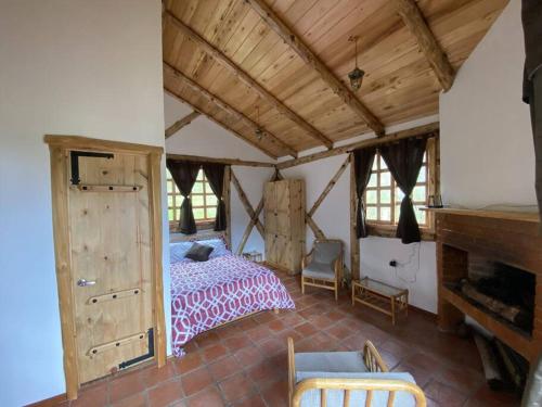 a bedroom with a bed and a fireplace at The Hideout- A Cabin in Nature; 25 min from Cuenca in Cuenca