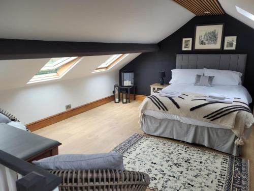 a bedroom with a bed in a room with skylights at Snowdon view, steam railway & Portmeirion nearby in Mynfford