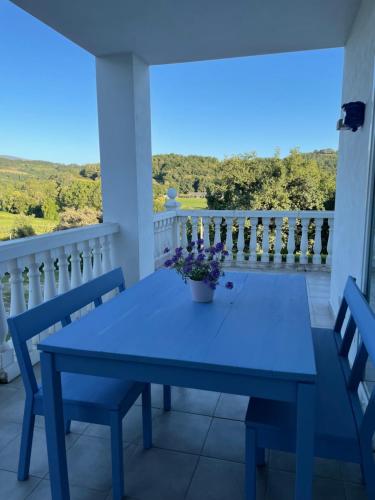a blue table and chairs on a balcony with a view at Casa Acougo, Sarria in Sarria