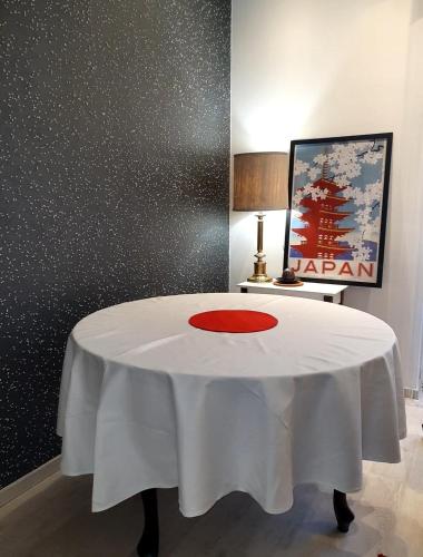 a white table with a red circle on top of it at Apartament City Center JAPAN - no smoking, free bottled water, coffea and tea in Koszalin