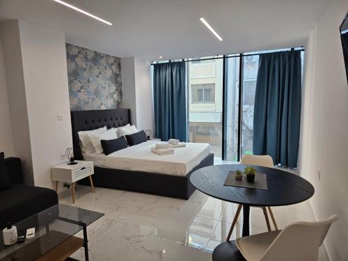 a bedroom with a bed and a table in a room at Nikis 20 Suites in Athens