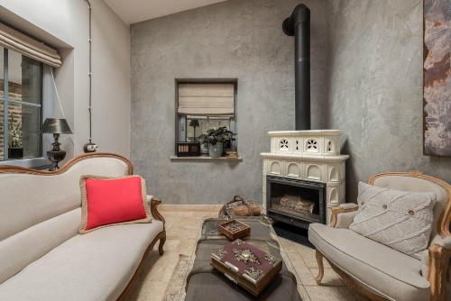 a living room with two couches and a fireplace at 7 STODOŁA - Hotel butikowy in Osiek