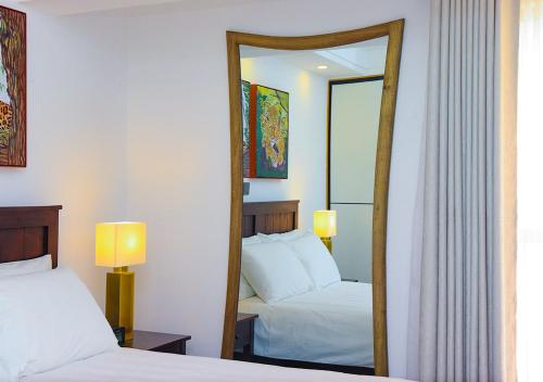 a hotel room with two beds and a mirror at Rose Manor - Cozy Luxurious 2 Bedroom Apartment in Kilimani Nairobi in Nairobi
