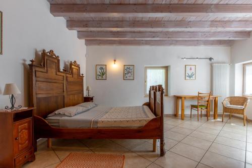 Un dormitorio con una gran cama de madera y una mesa. en Villa Villamonte, en Verona