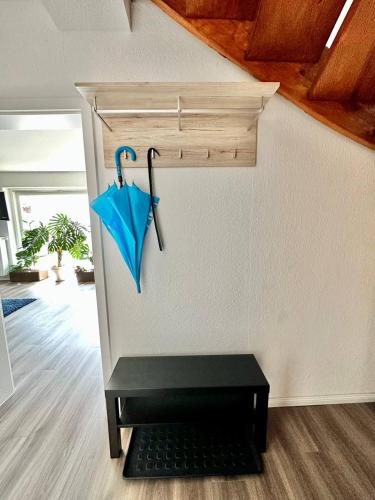 a blue umbrella is hanging on a wall at Großes City-Ferienhaus mit Terrasse, Grill und Parkplatz F19 in Oldenburg