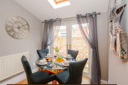 a dining room with a table and chairs and a window at New - Prospect lodge , City Centre Terraced House in York