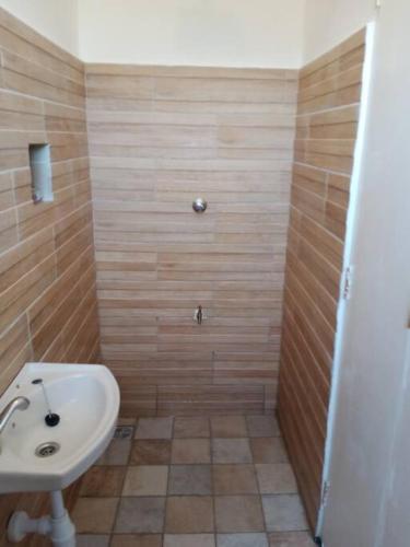 a bathroom with a sink and a shower at JiPende Penthouse in Kilifi