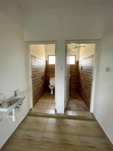 a bathroom with a sink and a toilet at JiPende Penthouse in Kilifi