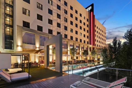 an exterior view of a hotel with a pool at Protea Hotel Fire & Ice! by Marriott Pretoria Menlyn in Pretoria