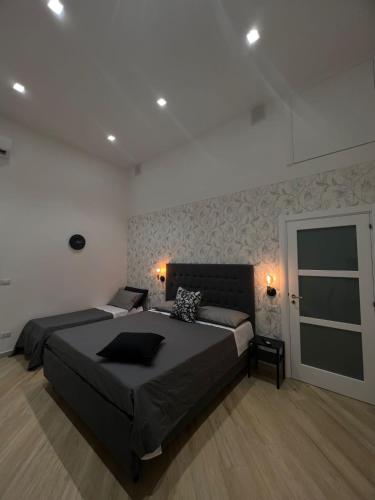 a bedroom with a large bed and a window at La Esperanza De Santa Rita in Bari