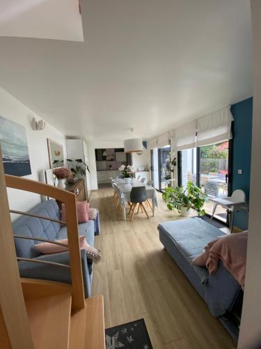 een woonkamer met 2 bedden en een eetkamer bij Chambre d’hôte près de la plage bis in Pornichet