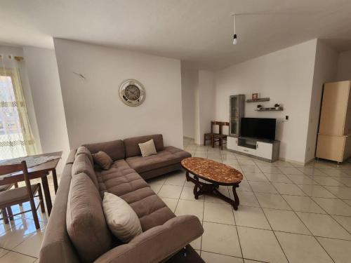ein Wohnzimmer mit einem Sofa und einem Tisch in der Unterkunft Apartment Number 1 Gym included in Vlorë