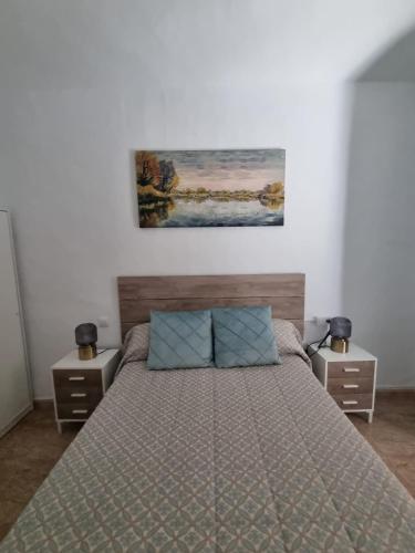 a bedroom with a bed and two night stands at AT SAN PEDRO 1 in Olivenza