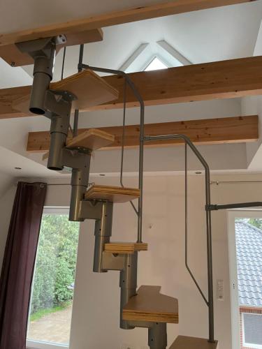 a spiral staircase in a house with a window at Ferienwohnung Wintermoor in Schneverdingen
