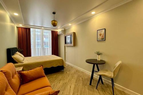 a room with a bed and a table and a couch at Your Corner in Batumi ! in Batumi
