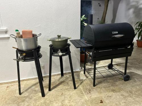 a bbq and a grill with two pots on it at R.G sol 2 in Pantoja