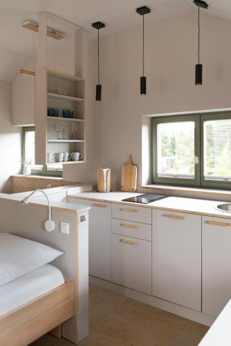 a kitchen with white cabinets and a window at Chalet Traumzeit in Weinböhla