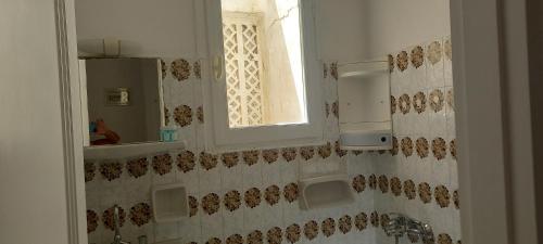 a bathroom with a sink and a window at Balcony to Aegeon 1 in Apollon