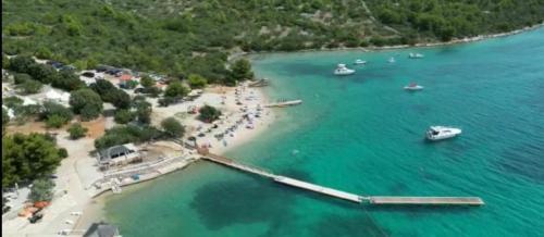 an aerial view of a beach with boats in the water at VORTEX mobile homes in Tisno