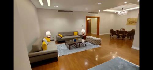 a living room with a couch and a table at Maison 7 New Cairo in Cairo