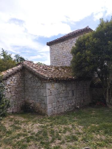an old stone building with a tree next to it at Chartreuse du XVIIIe in Saint-Créac