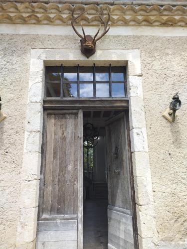 an entrance to a building with a wooden door at Chartreuse du XVIIIe in Saint-Créac