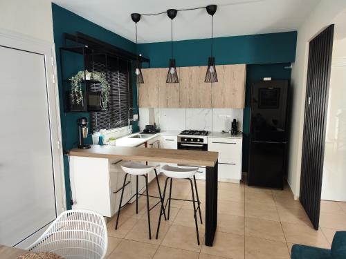 a kitchen with a table and stools in it at My Mythical Pearl in Protaras