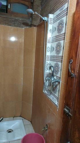 a bathroom with a sink and a toilet and a mirror at taghazout agadir appartement familiale in Taghazout
