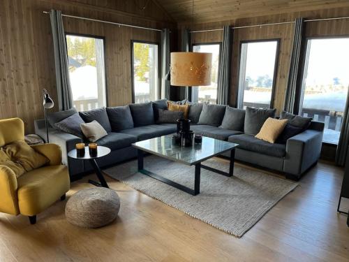 a living room with a couch and a coffee table at Hovdetunet 77-Gaustablikk in Gaustablikk
