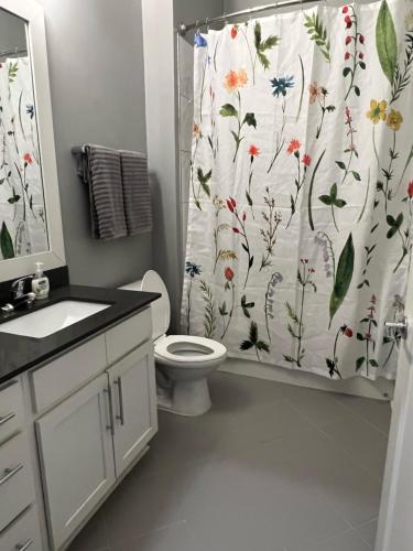 a bathroom with a toilet and a shower curtain at Luxury 1 Bedroom Apt in Plaza Midwood- Fast WiFi in Charlotte