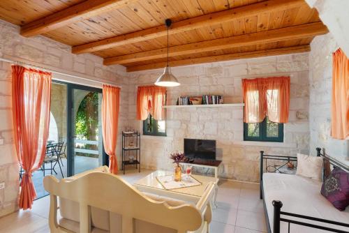 a living room with a couch and a table at Villa Terpsichore St George Retreat BY APOKORONAS-VILLAS in Kókkinon Khoríon