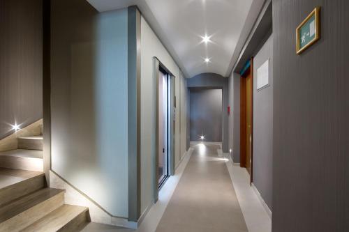 a hallway of a building with stairs and windows at Montespina Park Hotel in Naples