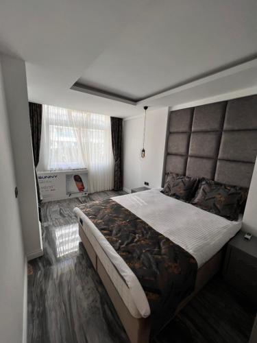 - une chambre avec un grand lit et une fenêtre dans l'établissement Sea town utku, à Antalya