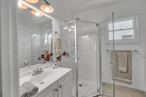 a white bathroom with a shower and a sink at Cactus Room - Private Entrance in Santa Barbara