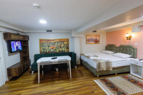 a hotel room with two beds and a television at Fidelya Boutique Hotel in Istanbul
