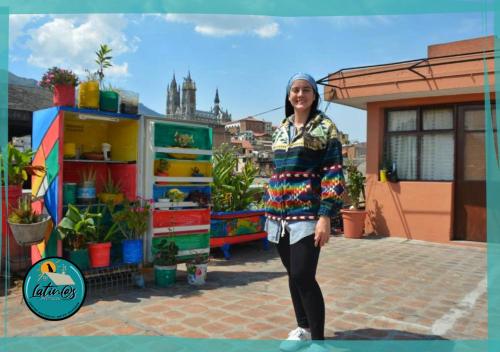 a woman is standing in front of a store at Latins Rooftop House in Quito