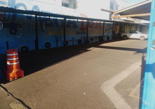 a bus parked in a parking lot with graffiti on it at ORSI HOTEL in Araguari