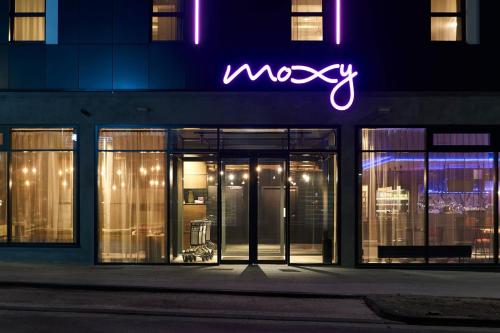 a neon sign on the side of a building at Moxy Essen City in Essen