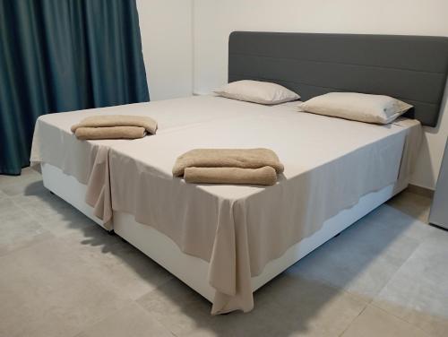 a bed with two towels on top of it at BluejSuite in Ayia Napa